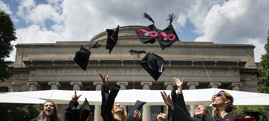 Graduates throwing the caps into the air