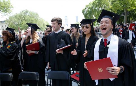 Graduates cheer for their peers from the audience