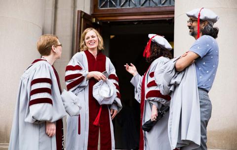 Doctoral candidates converse prior to the ceremoney; photo: Jake Belcher