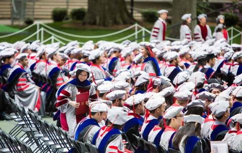 Mid-range shot of graduates taking their seats in Killian Court; photo: Jake Belcher