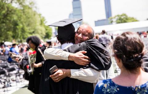 Graduate hugging family member