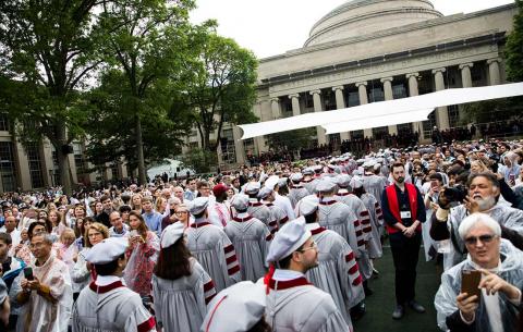 Doctoral candidates enter Killian Court; photo: Jake Belcher