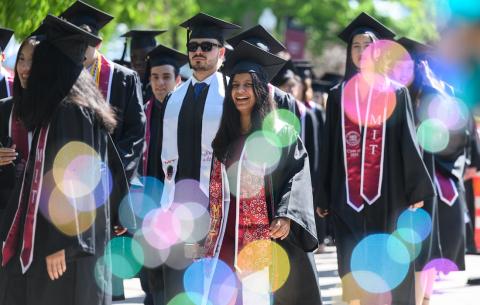 Image of graduates processing into Killian Court