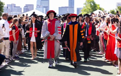 Image of the faculty division entering Killian Court