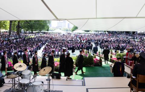 Image of the Commencement stage from the back, while graduates walk across